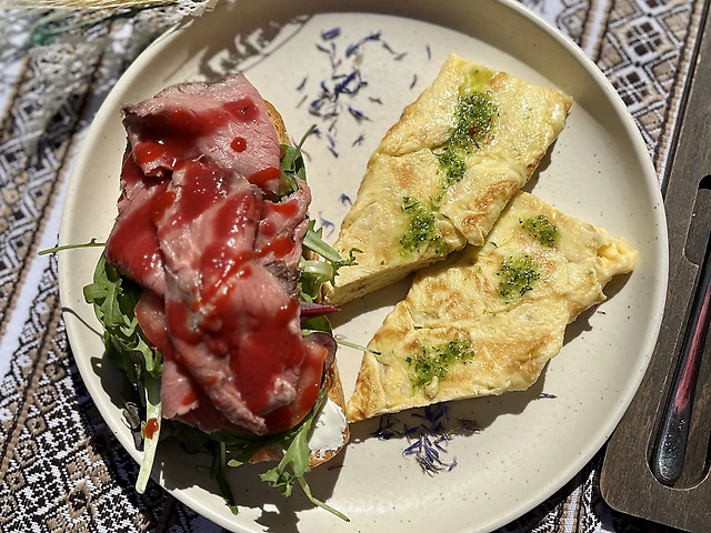 Breakfast with omelette and roast beef sandwich