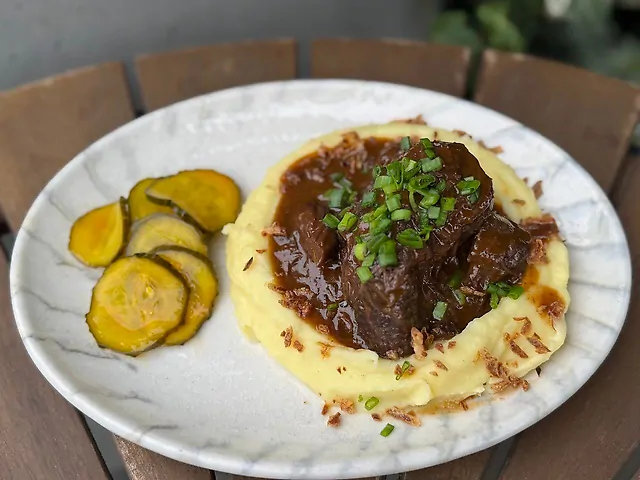 Яловичи щоки з картопляним пюре та огірками